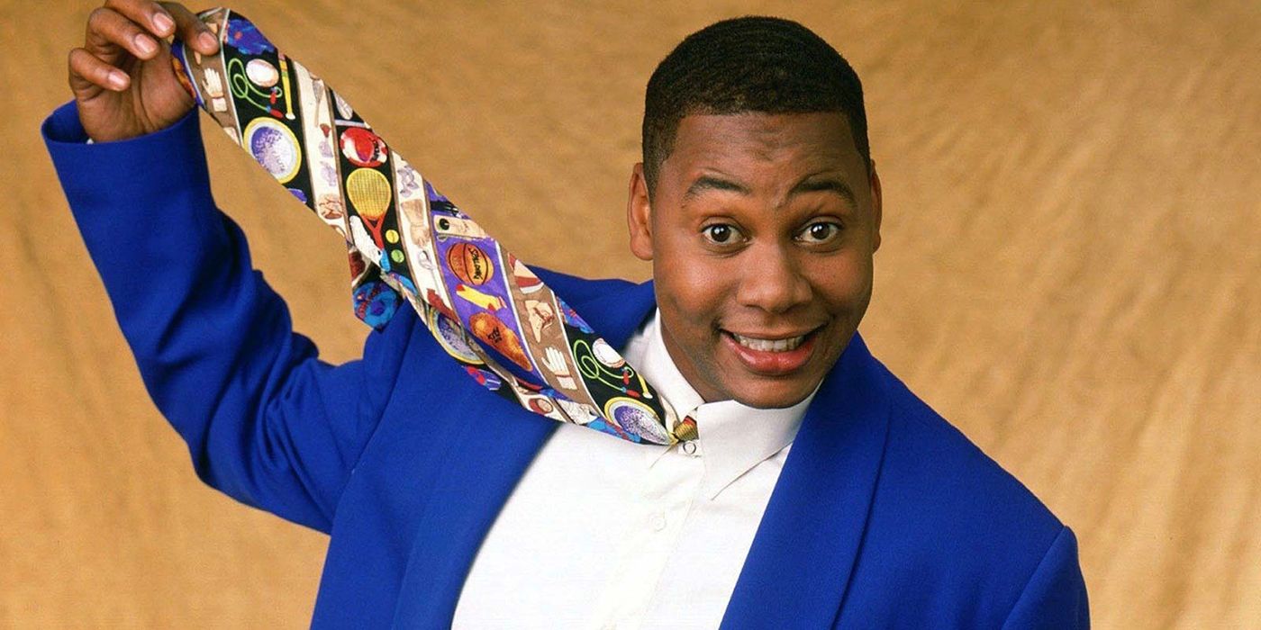 Mr. Cooper from Hangin' With Mr Cooper smiling while holding his colourful tie up in the air