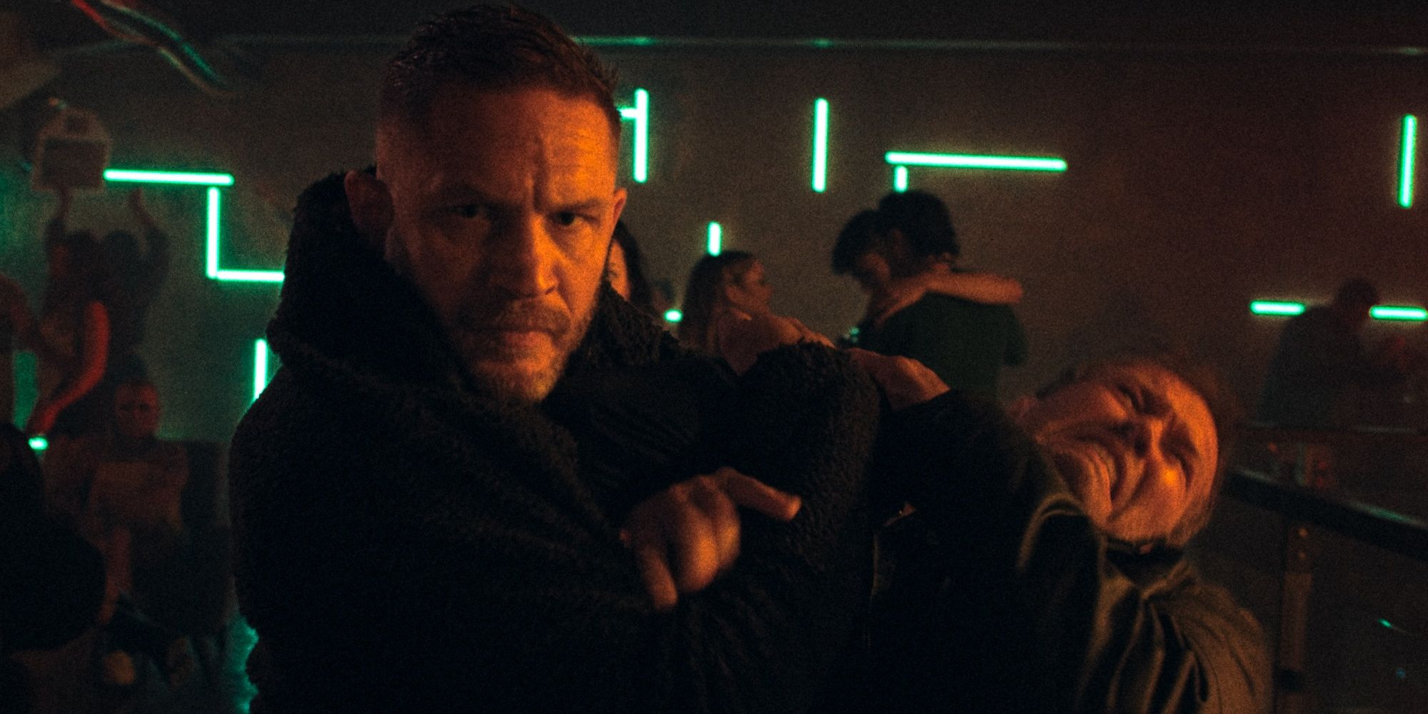 Tom Hardy as Walker fighting with someone inside a club in Havoc