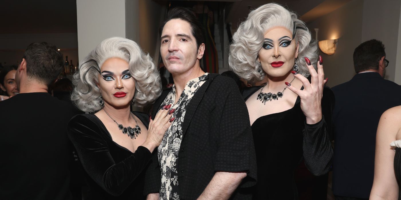 David Dastmalchian stands in between the Boulet Brothers who show off their red nails