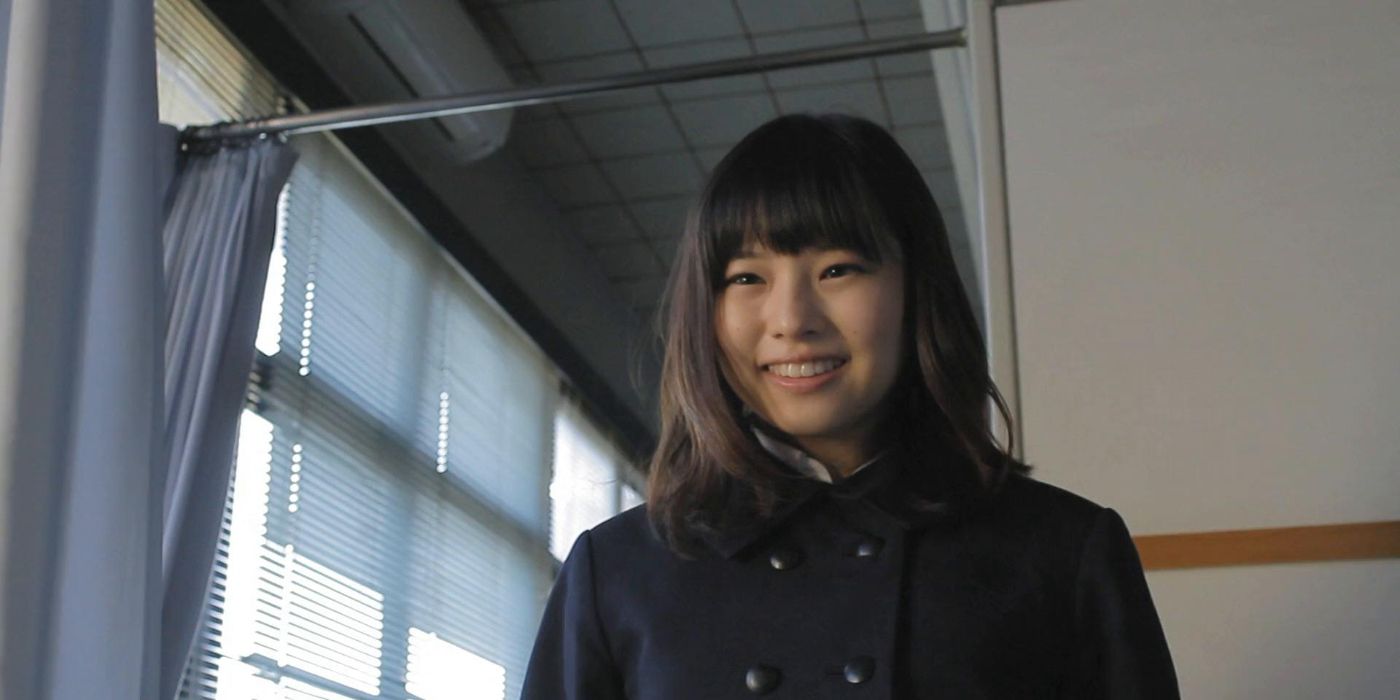 Izumi Okamura as Izumi, smiling gently at someone off-screen in Shady