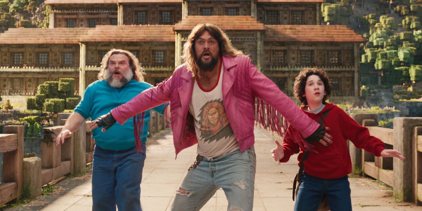 Steve (Jack Black), Garrett (Jason Momoa) and Henry (Sebastian Hansen) stop on a path in A Minecraft Movie.