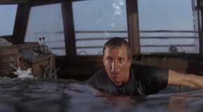 Roy Scheider as Martin Brody, up to his chest in water in a sinking boat in Jaws.