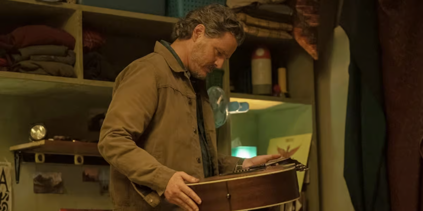 Joel (Pedro Pascal) holding a guitar in The Last of Us Season 2