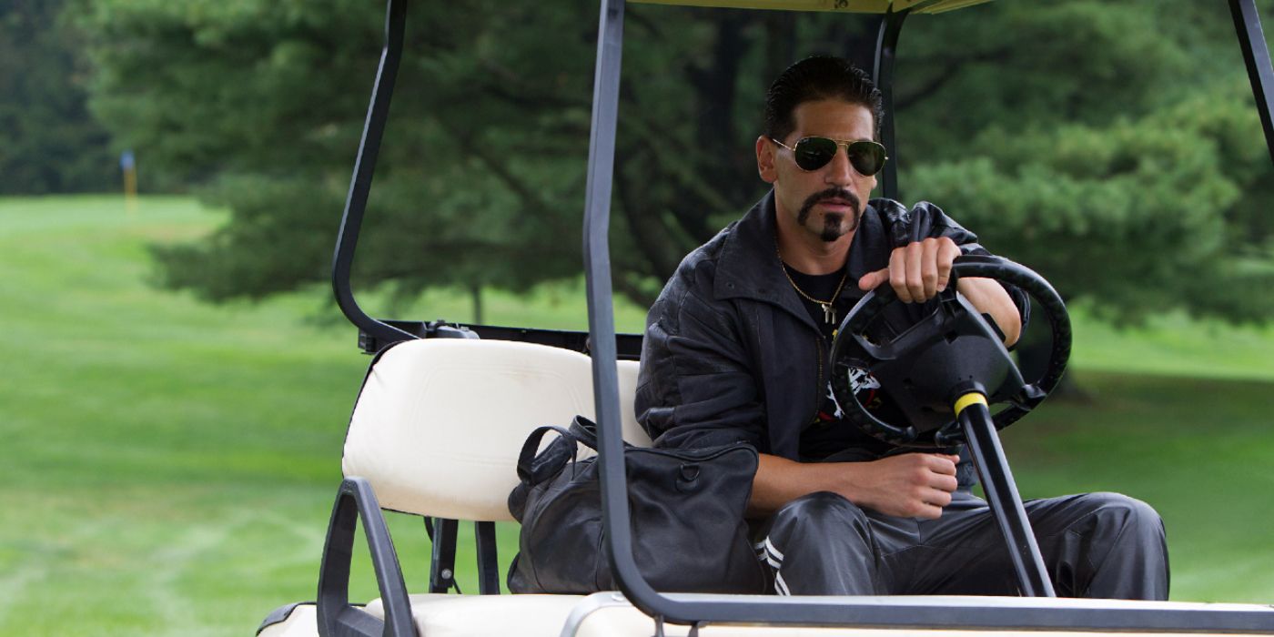 Jon Bernthal as Brad, wearing sunglasses and driving a golf cart in Wolf of Wall Street.