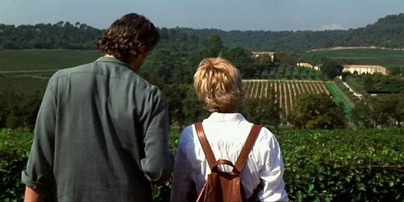 Kate and Luc look over a vineyard with their backs to the camera in 'French Kiss'.