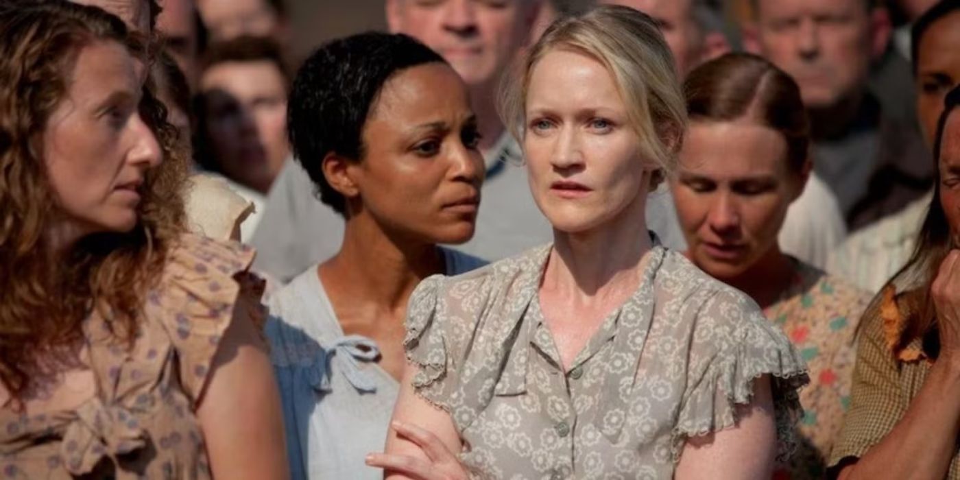 Paula Malcomson as Katniss' mother Asterid in a crowd at the Reaping ceremony in The Hunger Games.