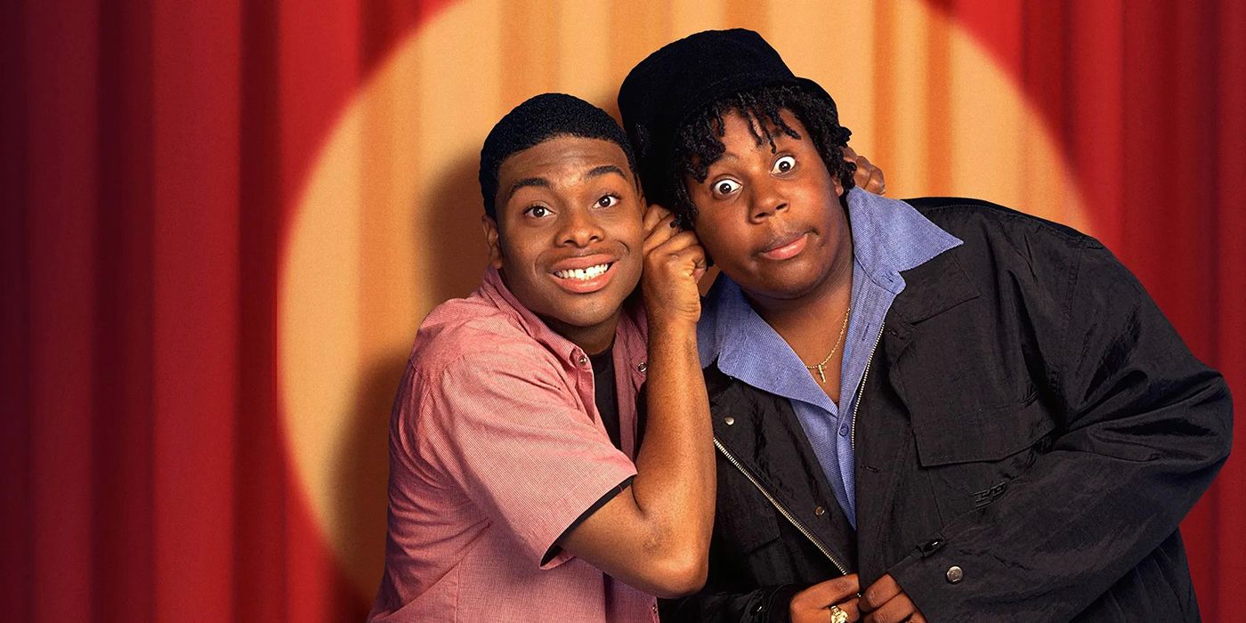 Kenan & Kel posing in front of stage curtains