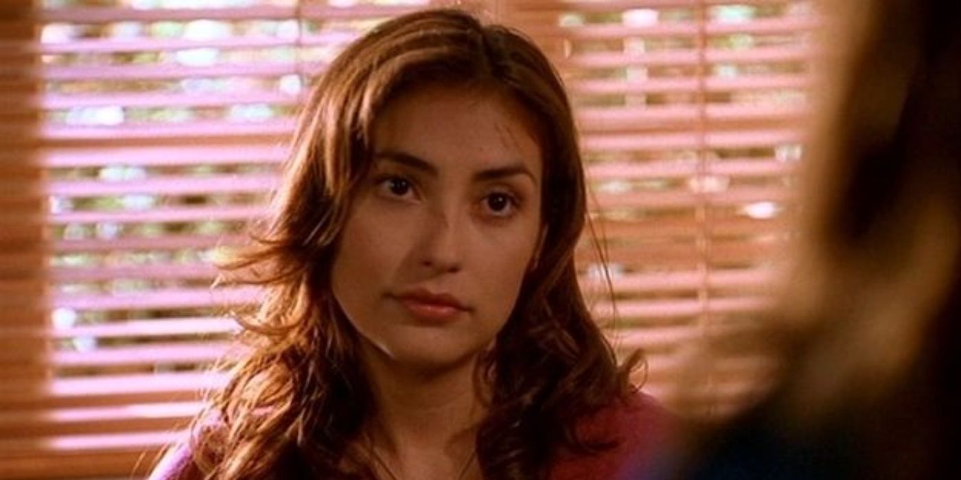 Iyari Limon as Kennedy with small scratches on her face, looking at someone in Buffy the Vampire Slayer.