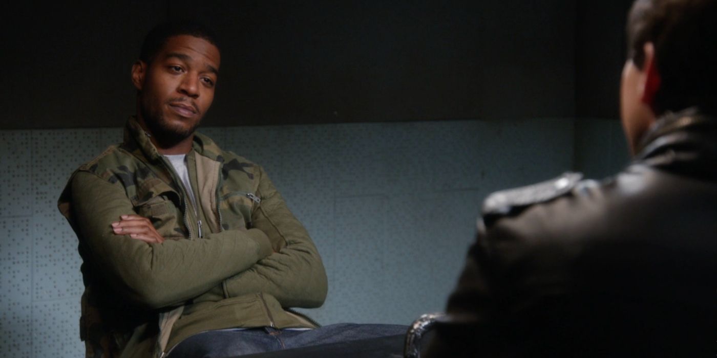 Dustin Whitman (played by Kid Cudi) sitting across from Jake Peralta (played by Andy Samberg), though you can only see some of Jake&rsquo;s back in &ldquo;Brooklyn-Nine-Nine.&quot;