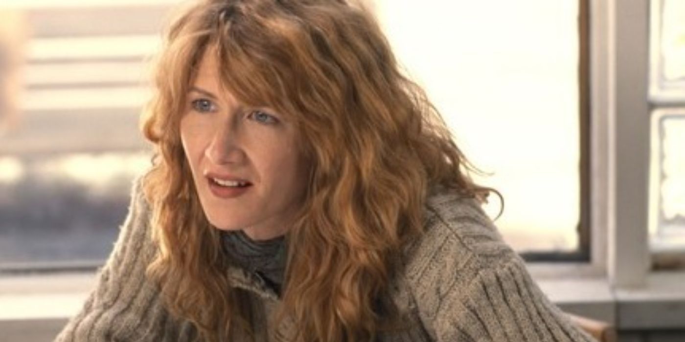 Laura Dern looks across a table at someone off-camera in We Don't Live Here Anymore.
