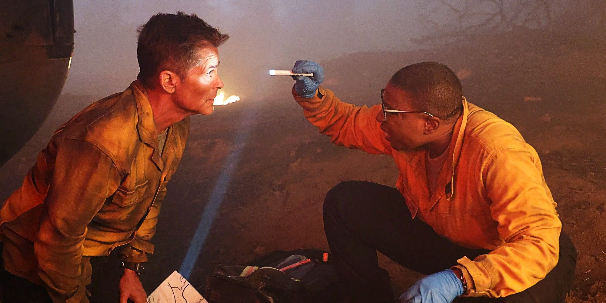 Hen Wilson checking Owen Strand for injuries in the crossover episode between 9-1-1 and 9-1-1: Lone Star.