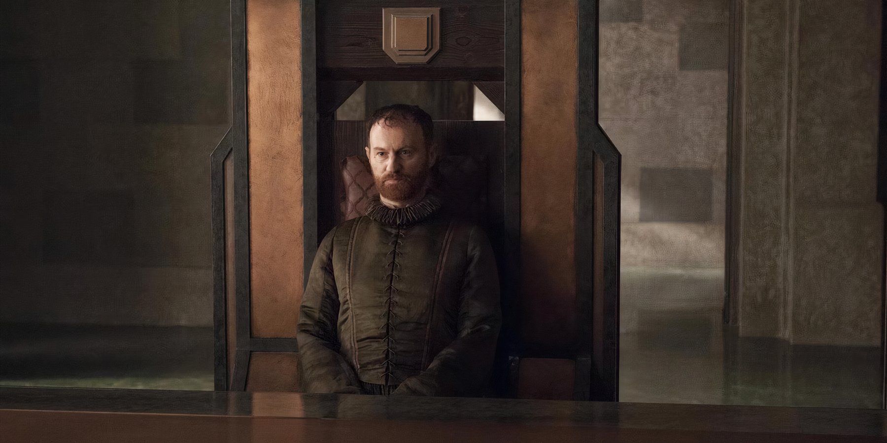 Mark Gatiss as Tycho Nestoris on Game of Thrones sitting in a chair looking stoic.