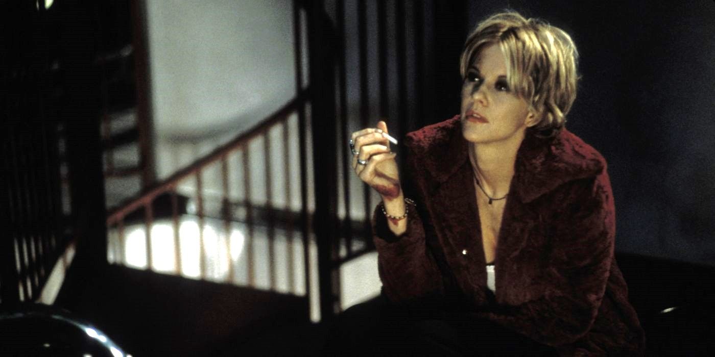 Meg Ryan smokes a cigarette on a dark staircase in Hurlyburly.