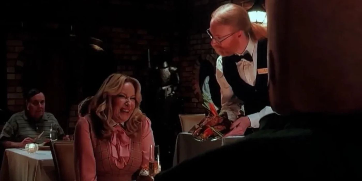 Jens Bergensten as a waiter in a restaurant next to Jennifer Coolidge in A Minecraft Movie.