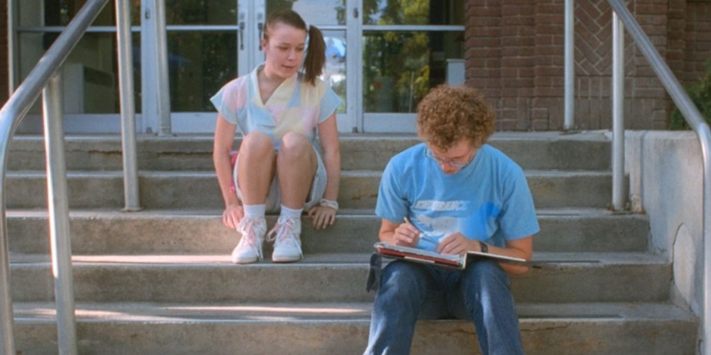 Deb and Napoleon sit on the steps outside school in Napoleon Dynamite.