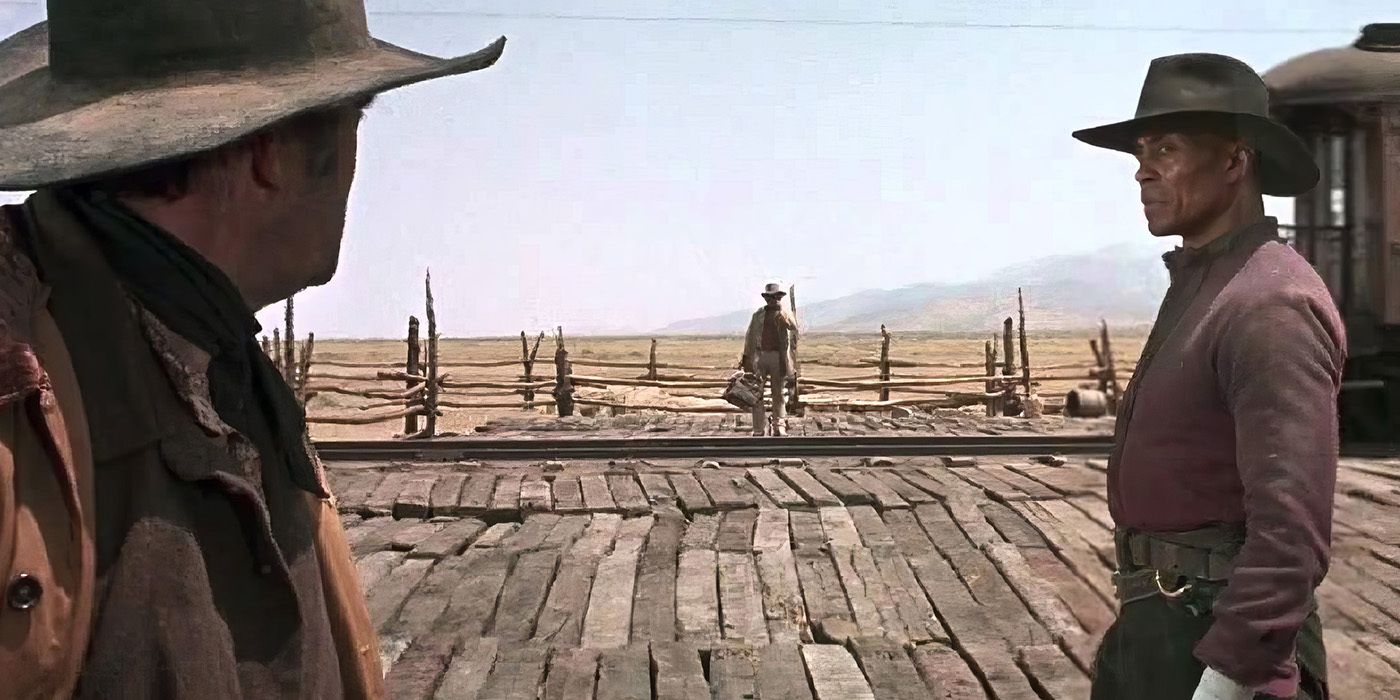 Snaky (Jack Elam) and Stony (Woody Strode) look at Harmonica (Charles Bronson) standing by in 'Once Upon a Time in the West'