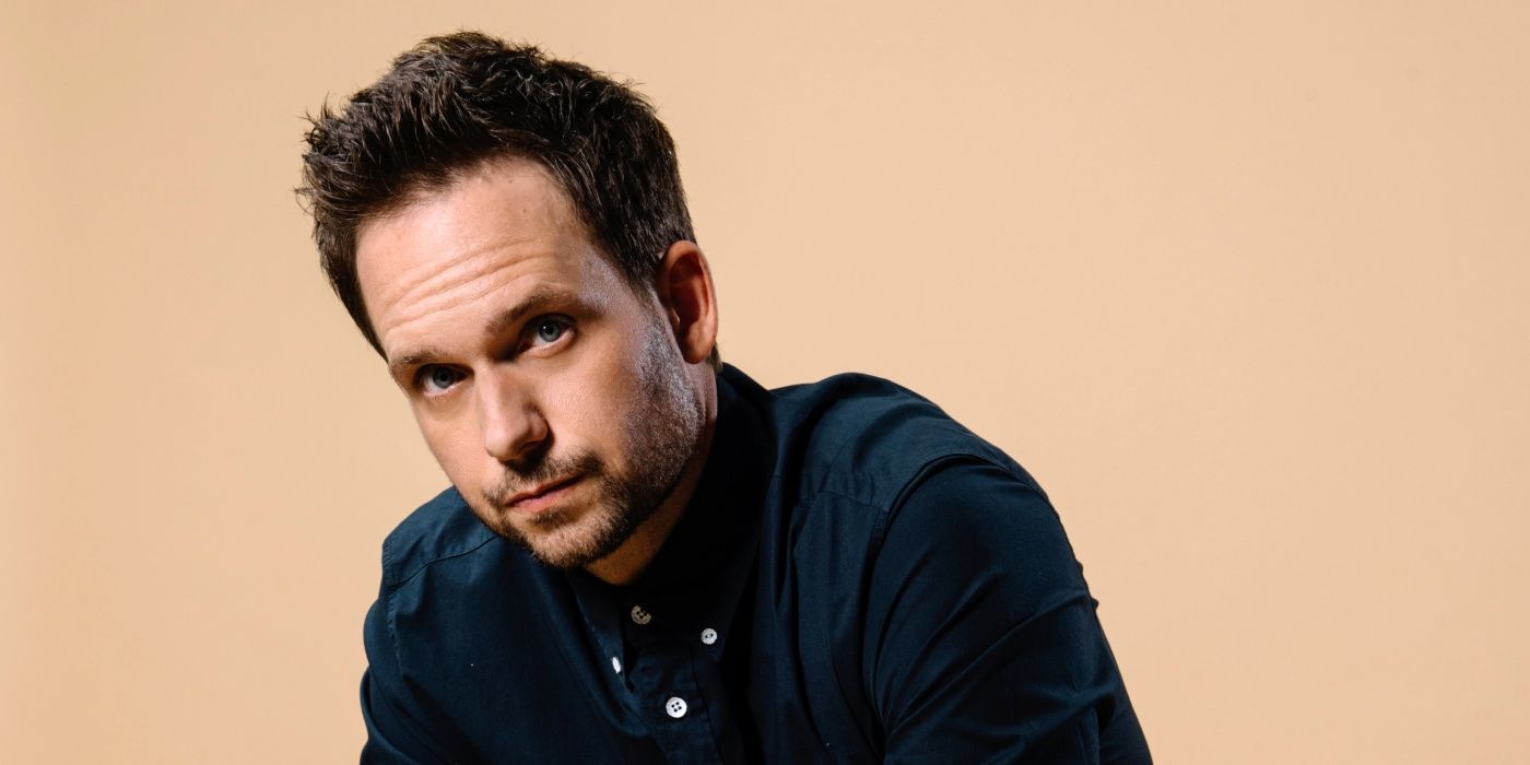 Patrick J. Adams posing in a promo gallery shot looking serious with his forhead crinkled in a dark shirt