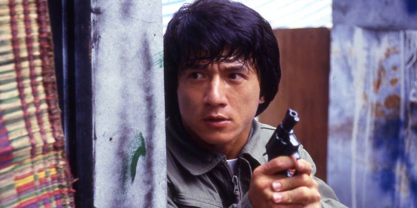 Jackie Chan as Sergeant 'Kevin' Chan Ka-Kui hiding around a corner with a gun in Police Story.