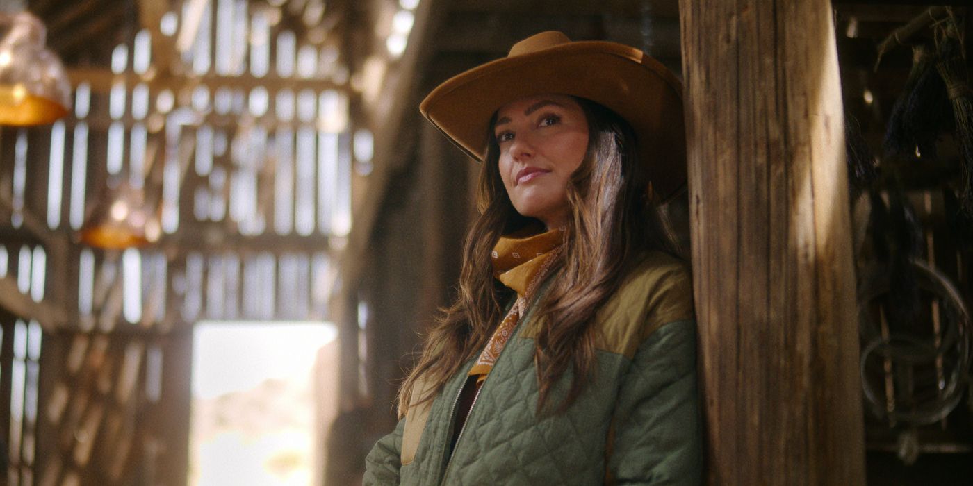 Minka Kelly in a cowboy hat leans against a post in Ransom Canyon