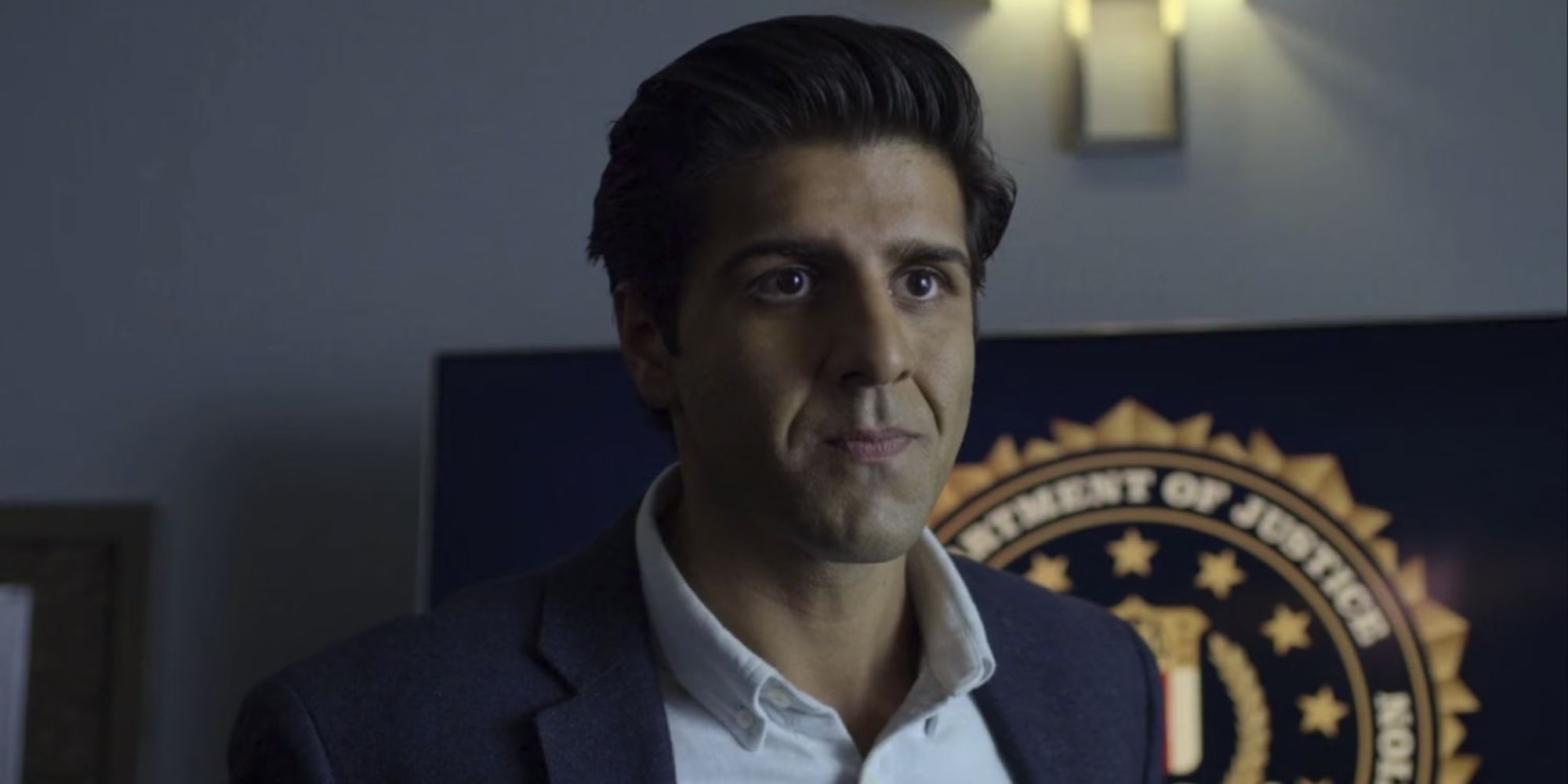 Jay Ali as Rahul Nadeem in front of a podium that has a &ldquo;Department of Justice&rdquo; seal in Daredevil.