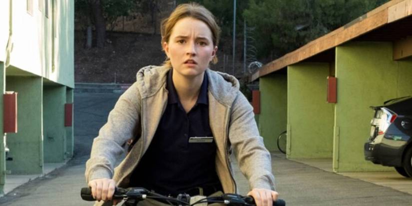Kaitlyn Dever as Marie Adler wearing a grey hoodie riding her bike in 'Unbelievable