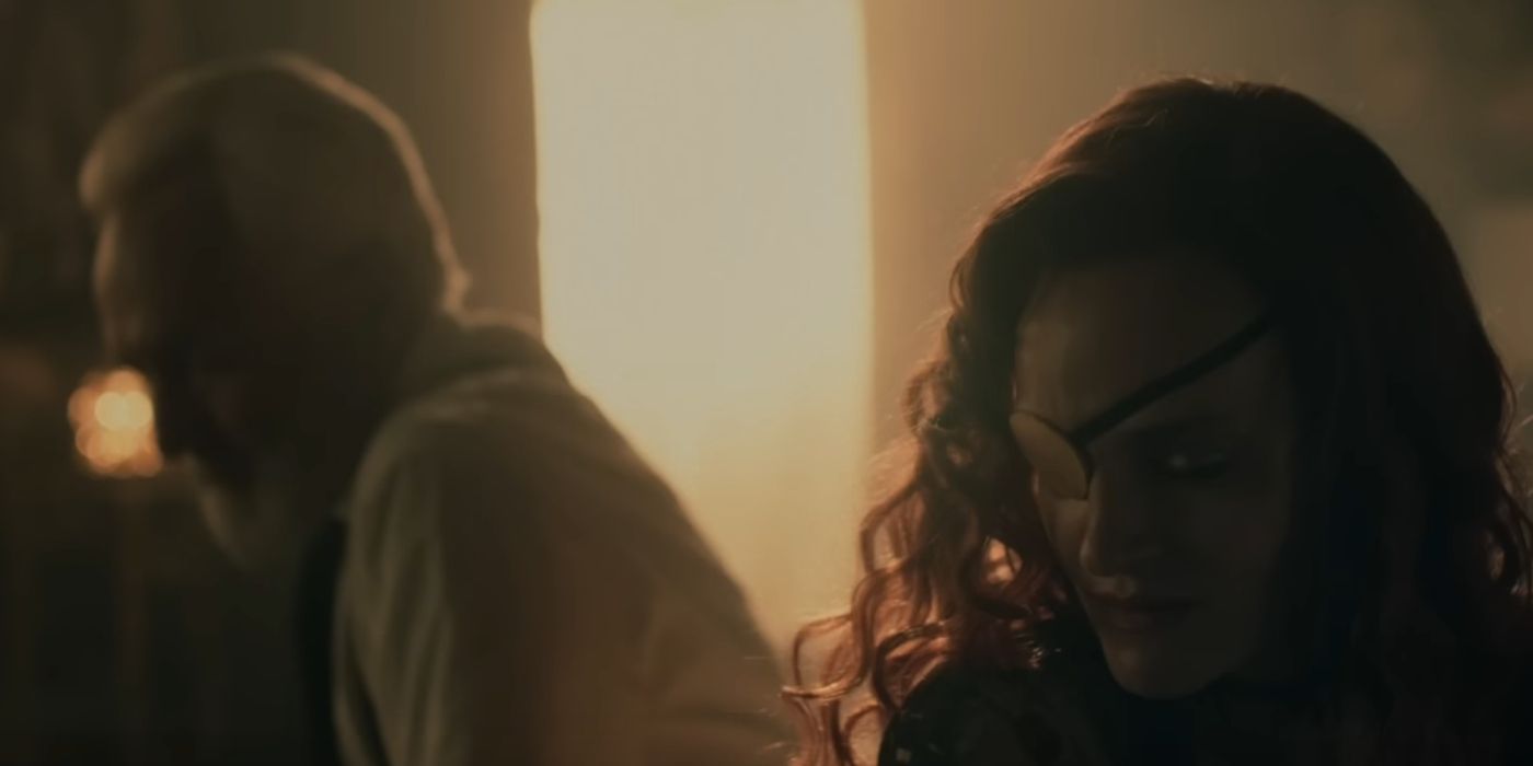 Madeline Brewer as Janine and Bradley Whitford as Commander Lawrence sitting together on a bed in The Handmaid's Tale.