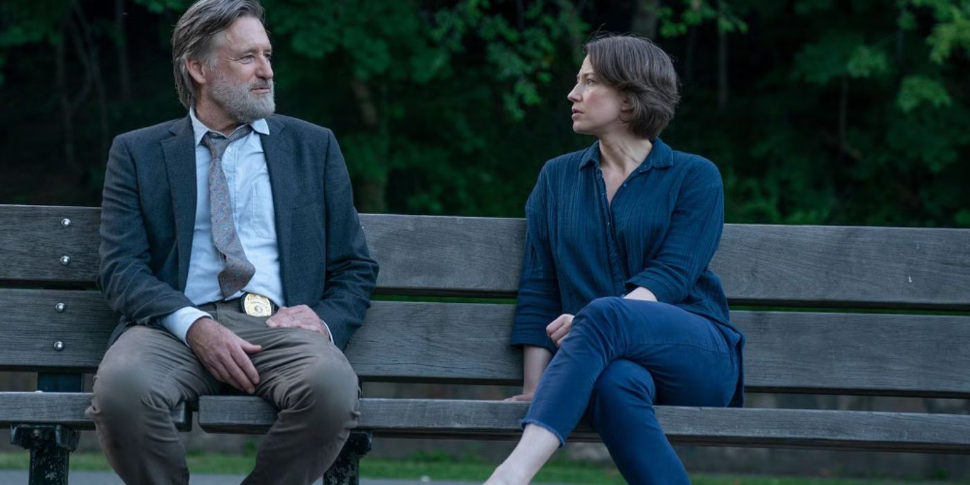 Bill Pullman and Carrie Coon as Detective Ambrose and Vera sitting on a bench both wearing blue shirts in &lsquo;The Sinner.'