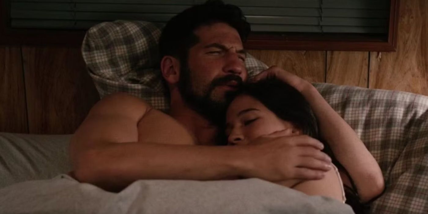 Jon Bernthal as Matt and Kelcey Asbille as Natalie cuddling naked in bed in Wind River.