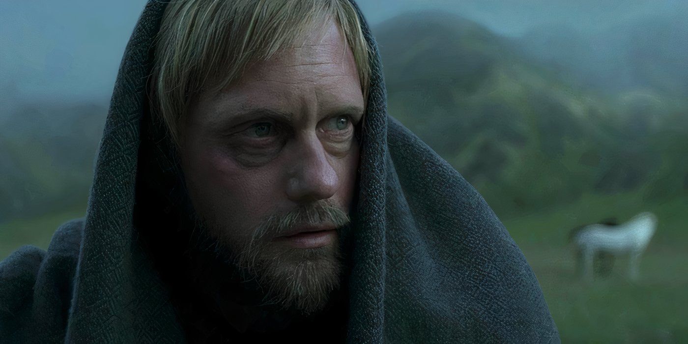 Alexander Skarsgård as Amleth looking thoughtfully into the distance with a shroud on his head in The Northman.
