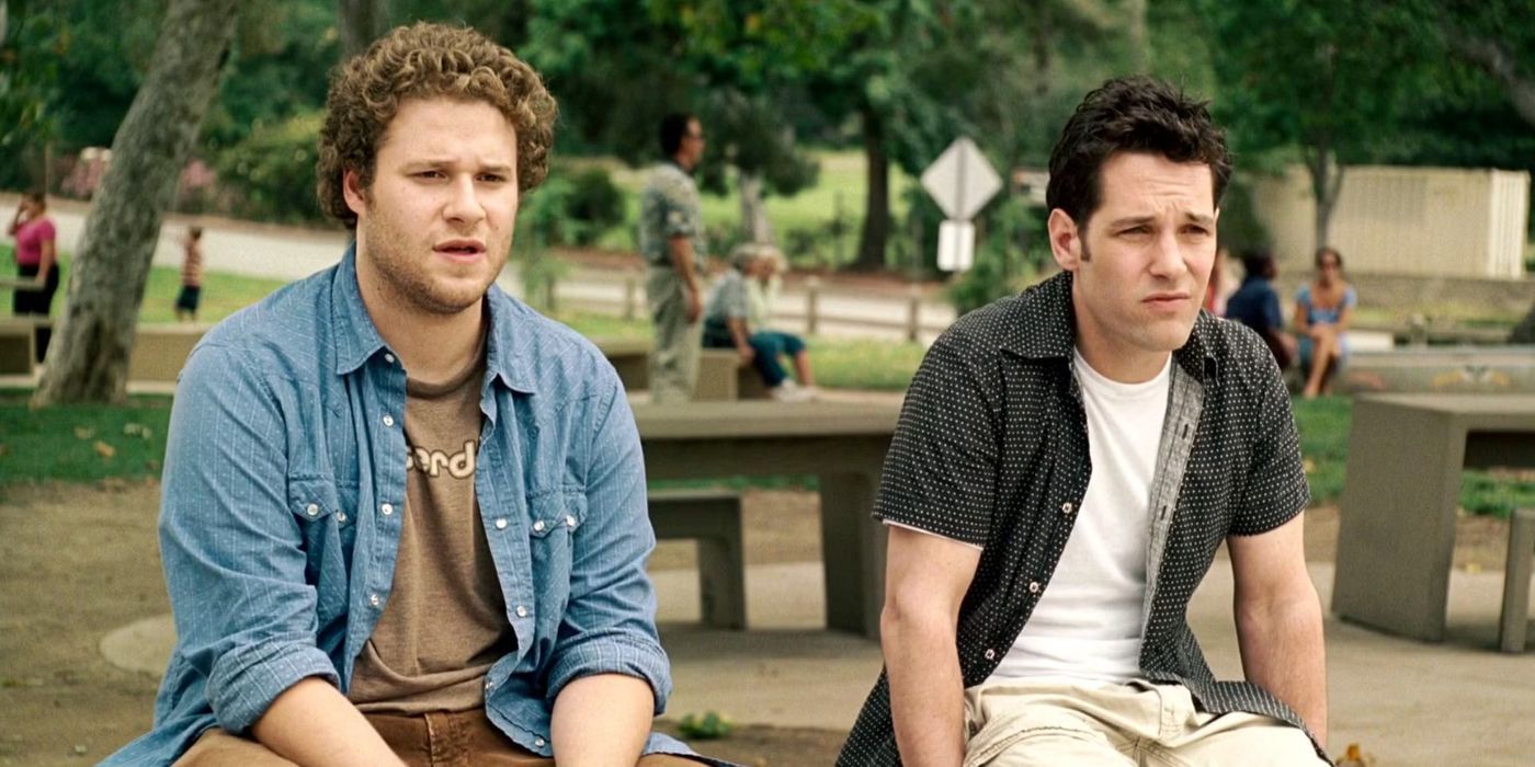 Seth Rogen and Paul Rudd sit on a bench and stare into the distance in Knocked Up.