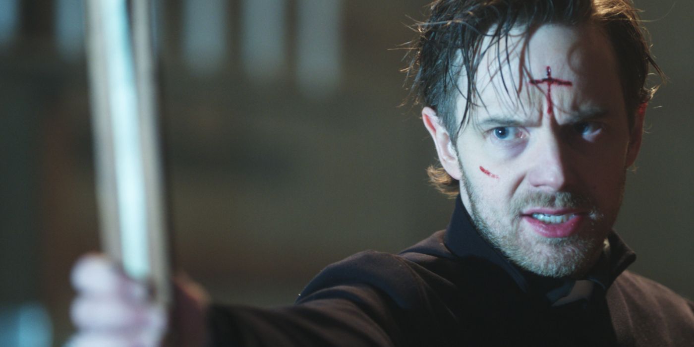 Mark O&rsquo;Brien as Mason holding an upside down cross in Shadow of God.