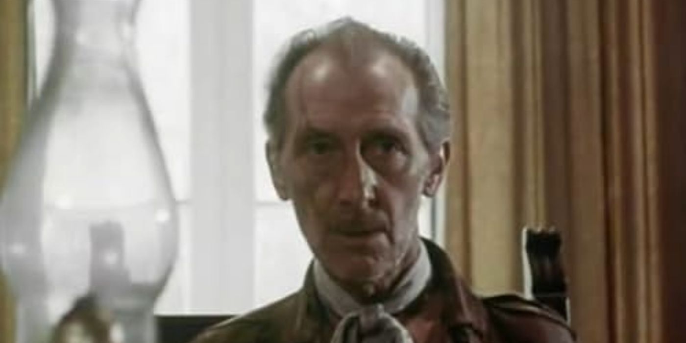 Peter Cushing as the S.S. Commander, sat at a table in Shock Waves.