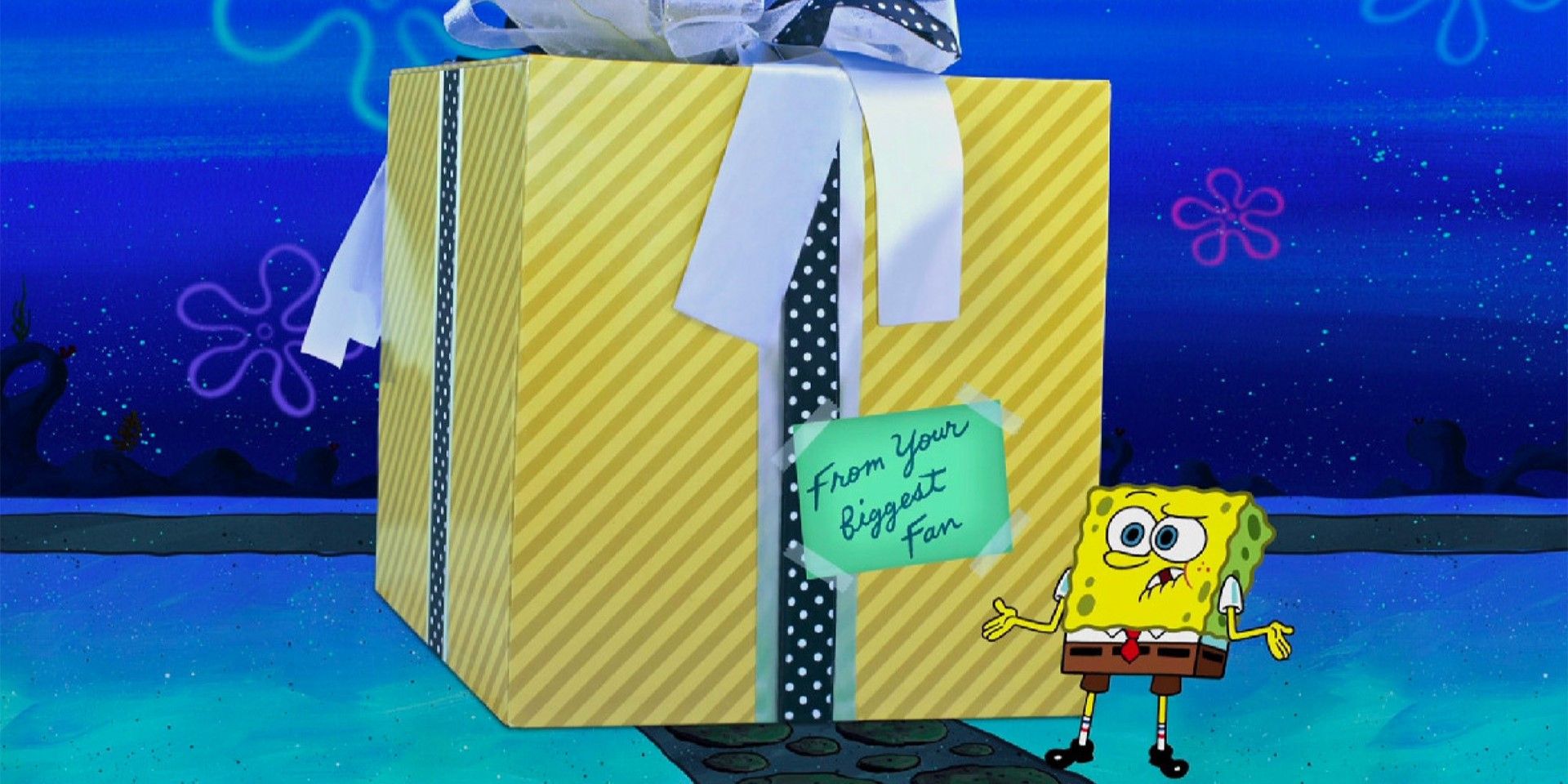 SpongeBob looks confused by a giant birthday present from his biggest fan in SpongeBob SquarePants.