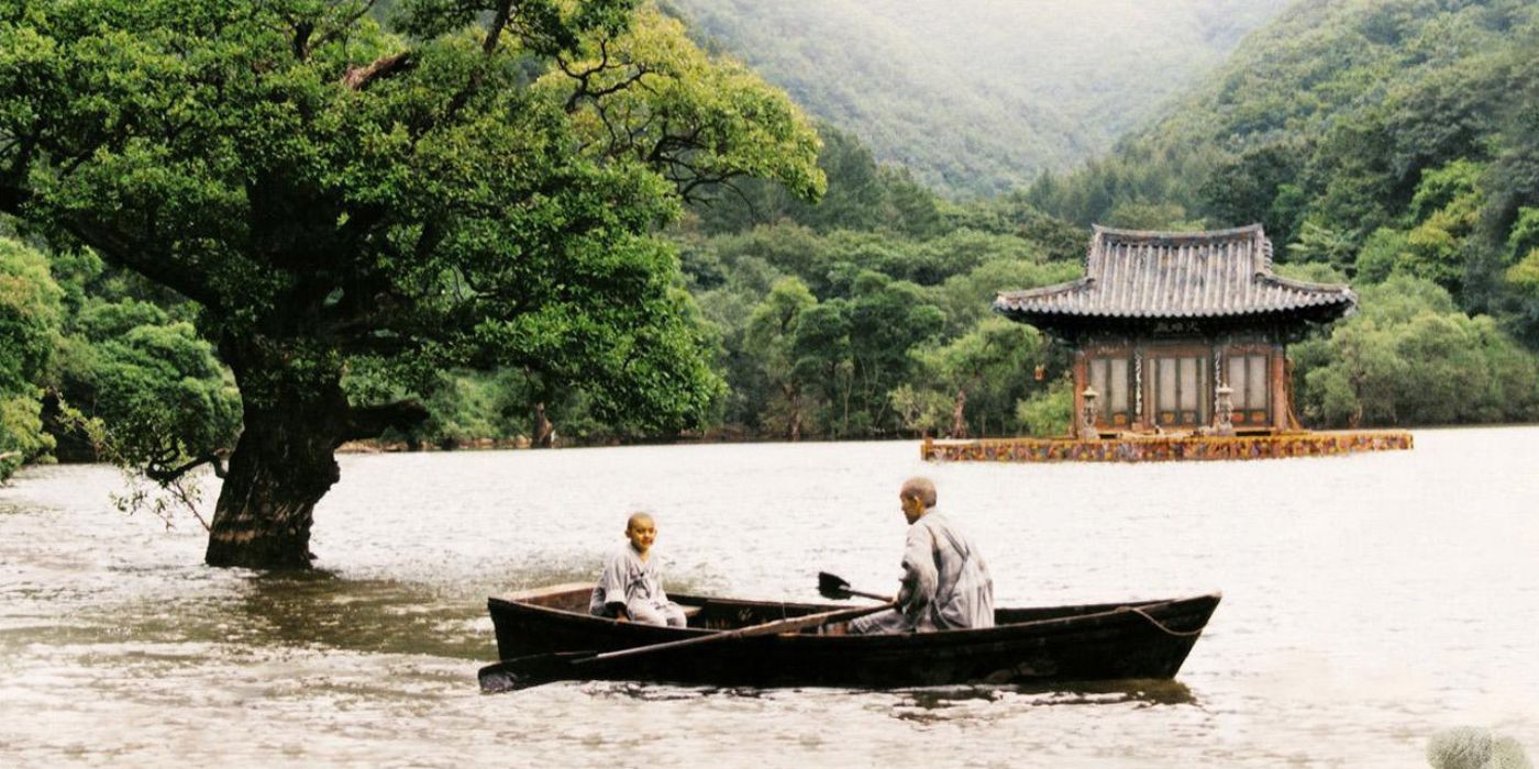 A still of a Buddhist temple and two monks on a boat from the Korean movie Spring, Summer, Fall, Winter... and Spring