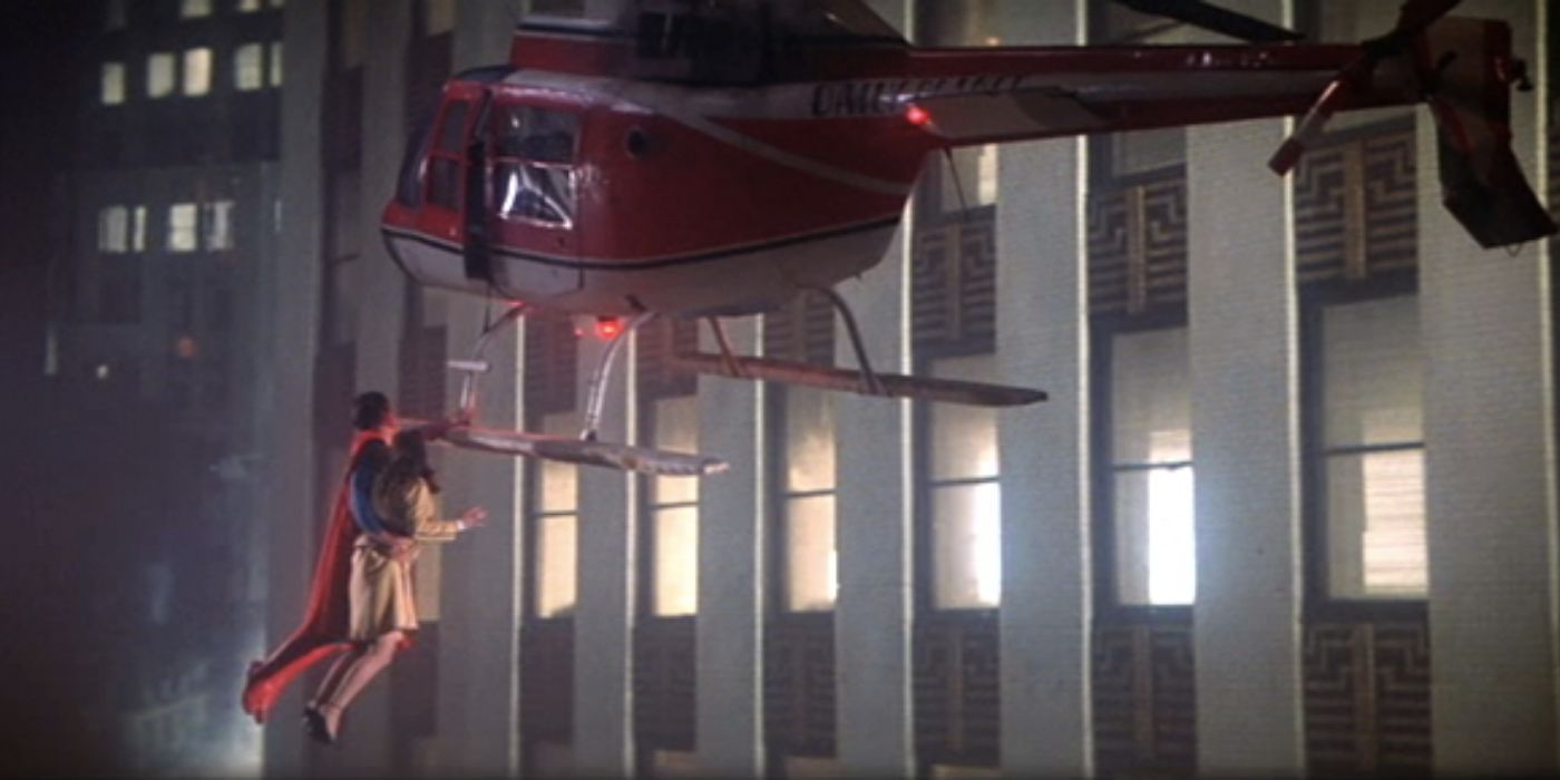 Superman holding Lois Lane and a helicopter