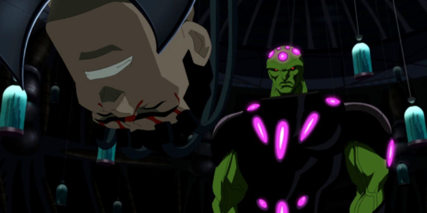 Braniac looks at a wincing Superman in Superman Unbound