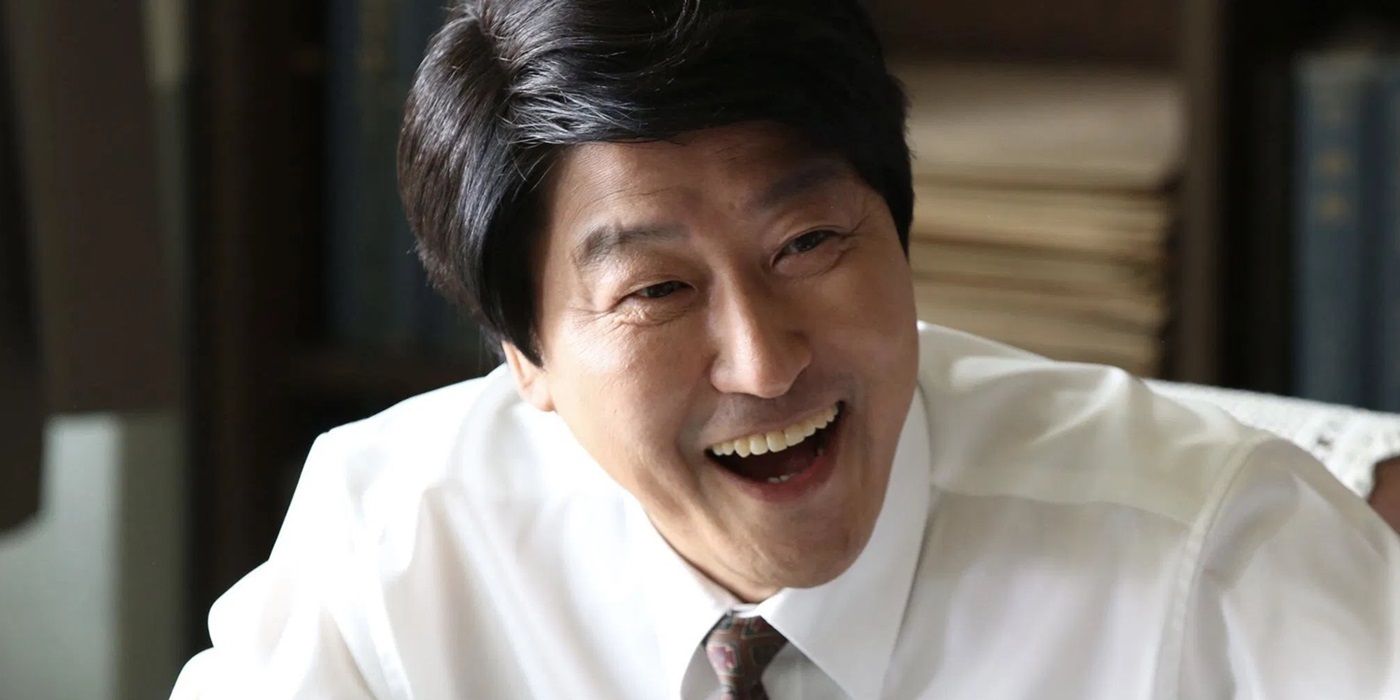 Song Kang-ho as Song Woo-seok smiling widely in The Attorney