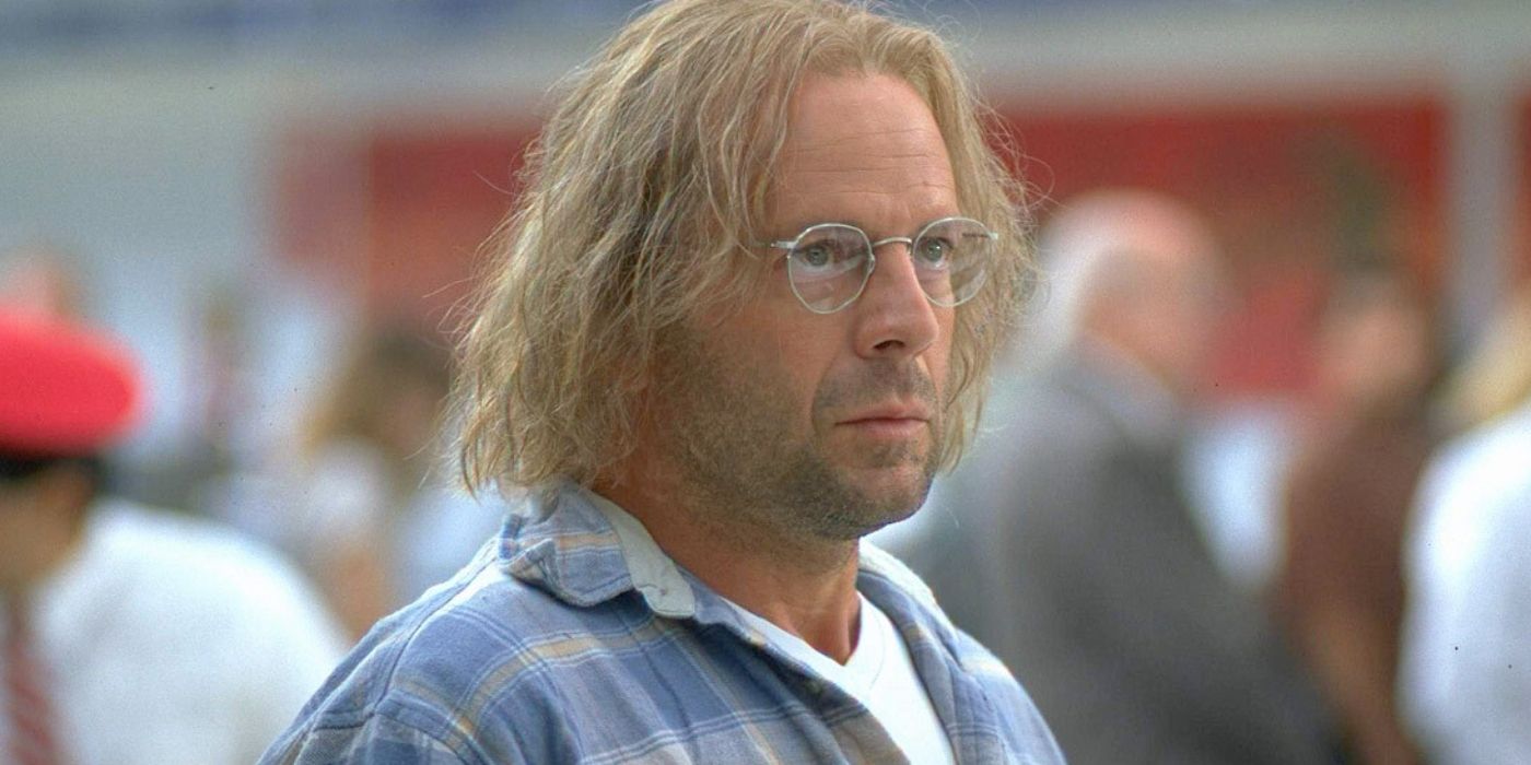 Bruce Willis as The Jackal disguised in glasses and blonde wig in The Jackal.