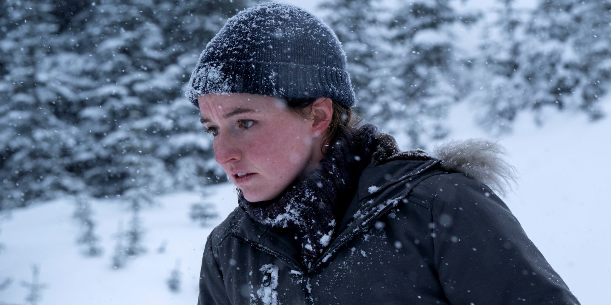 Kaitlyn Dever as Abby walking through the snow in a hooded coat lined with fur in The Last of Us Season 2