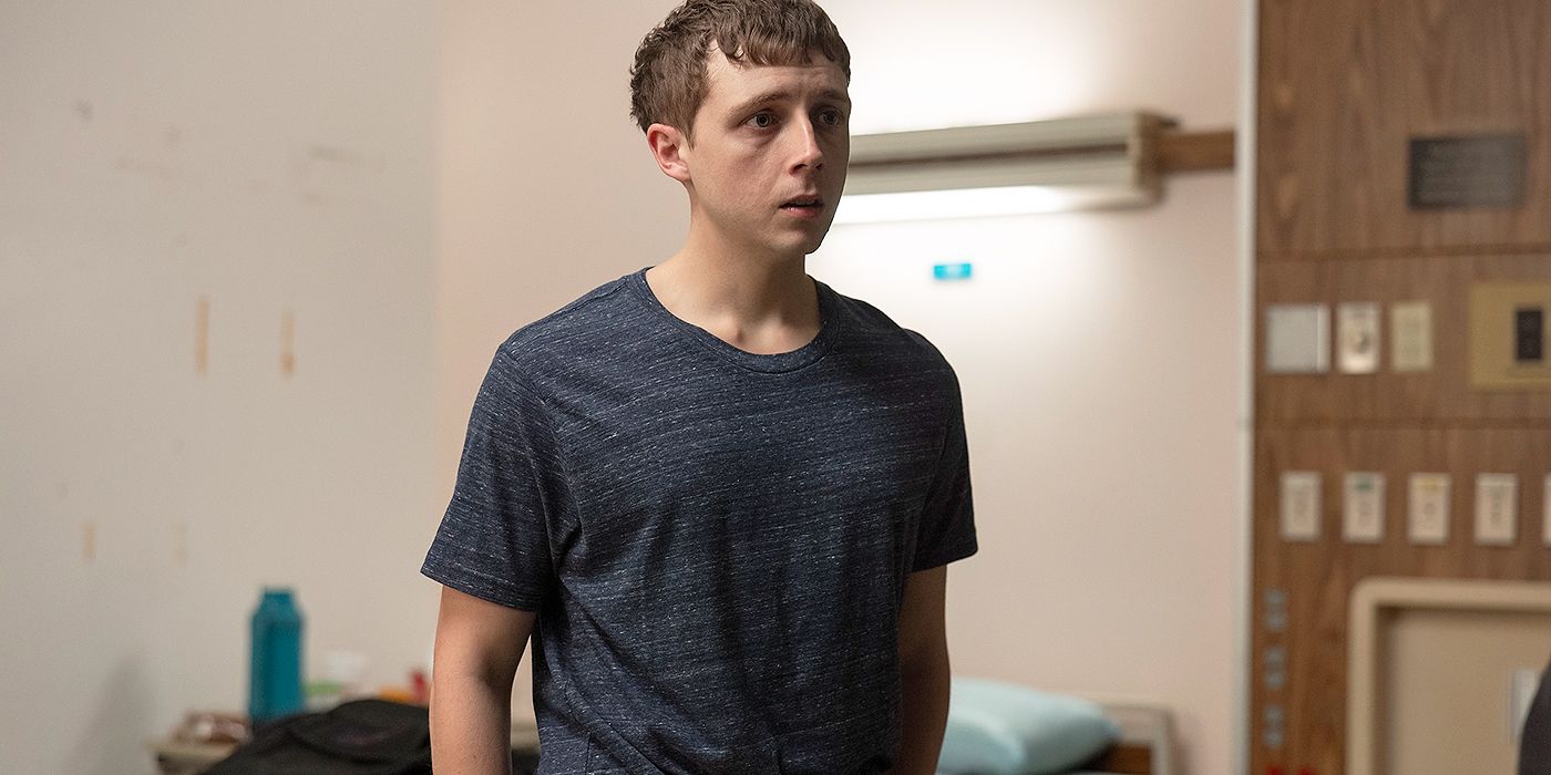 Gerran Howell as Dr. Whitaker standing in a hospital room in The Pitt Season 1, Episode 15.