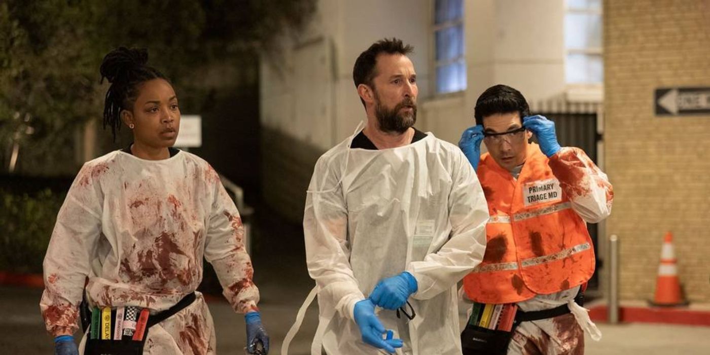 Robby (Noah Wyle), John Shen (Ken Kirby), and Parker Ellis (Ayesha Harris) wearing scrubs outside the hospital in The Pitt.