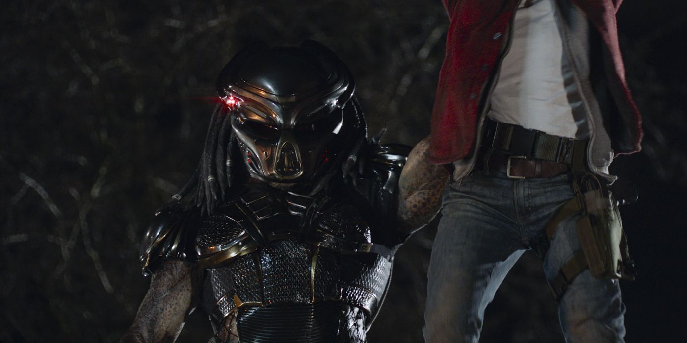 The Fugitive Predator holding a man up in the air with his left arm in The Predator.