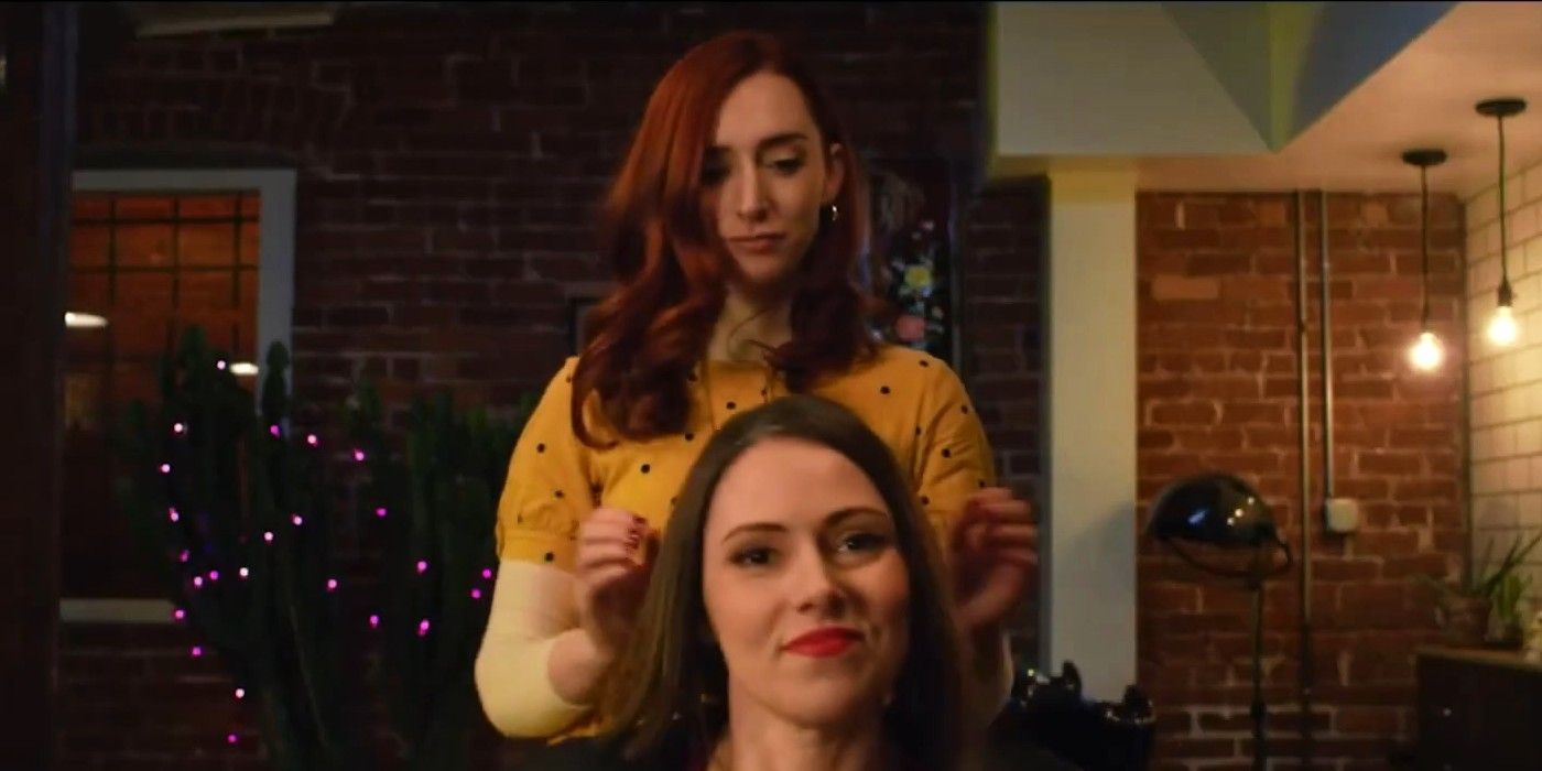Jennifer Seward in a salon chair while Najarra Townsend examines her hair behind her in The Stylist.