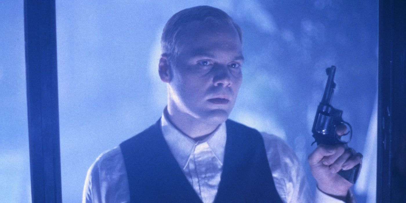 Ashton (D'Onofrio) looking sinister holding a gun 