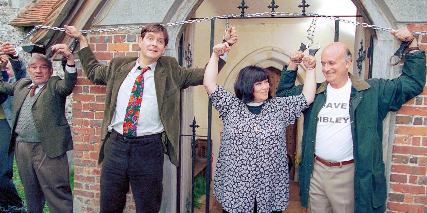Dawn French as Geraldine Granger chained to a church gate with others in The Vicar of Dibley.