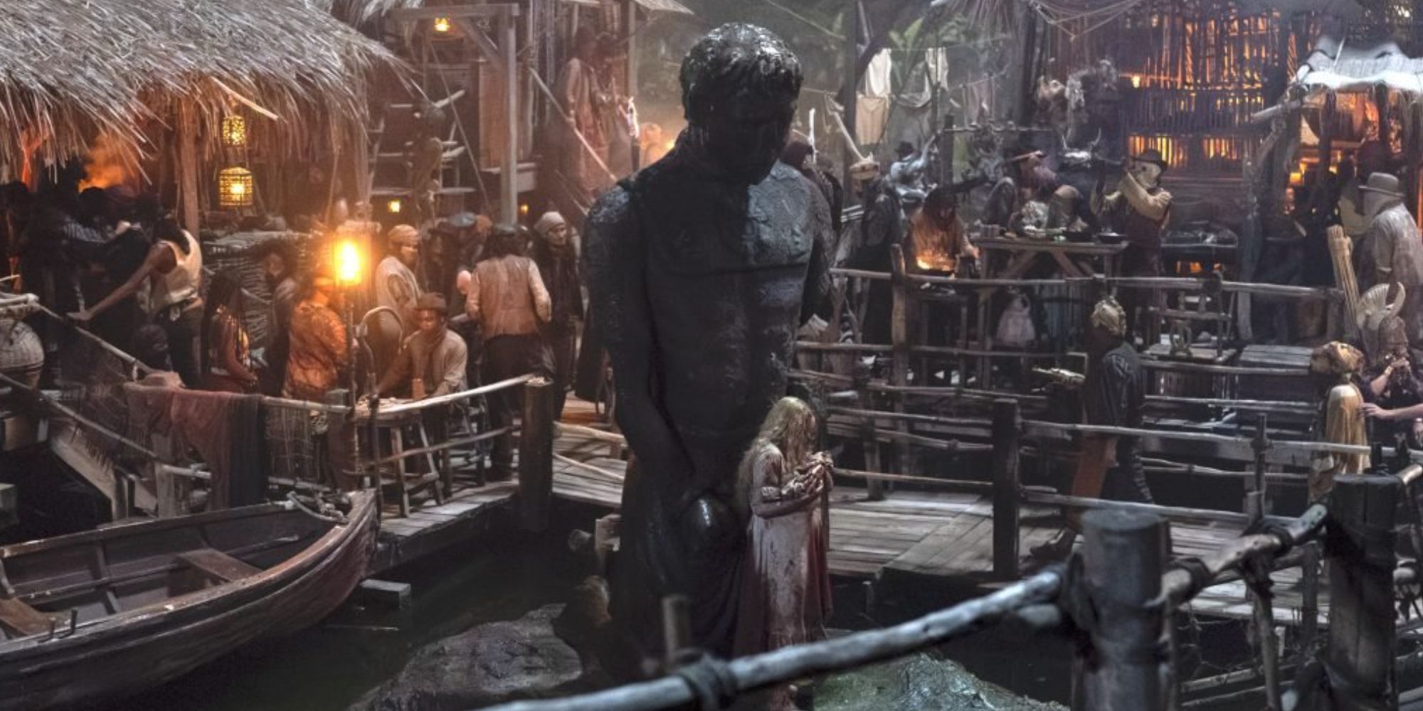 A girl standing alone by a statue surrounded by the busy docks of Tanchico in The Wheel of Time Season 3