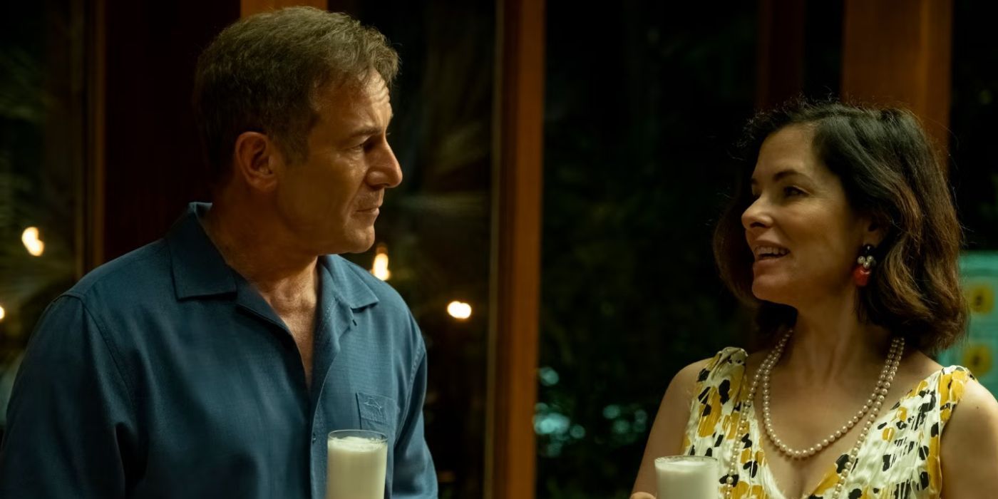 Jason Isaacs as Timothy drinking with Parker Posey as Victoria in The White Lotus Season 3, Episode 8.