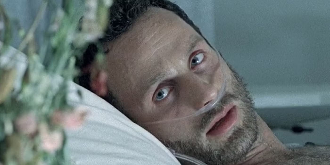 Rick Grimes in bed with a breathing tube in his nose looks to his right in The Walking Dead.