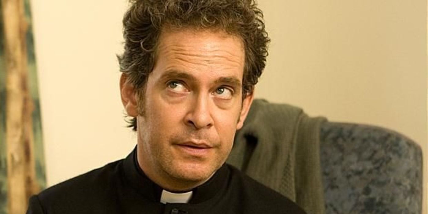 Tom Hollander as Rev. Adam Smallbone sitting in a chair and looking off-camera in Rev.