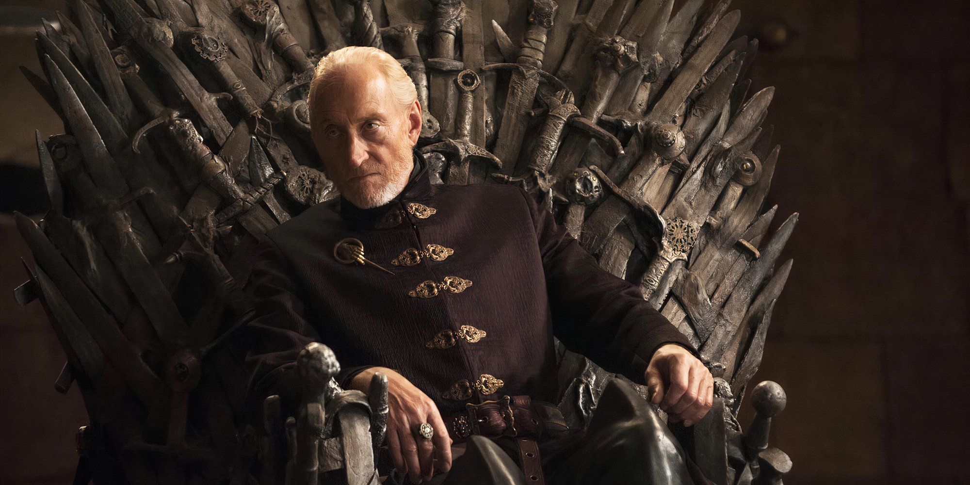 Tywin Lannister, while leaning slightly, sits on the Iron Throne in Game of Thrones.